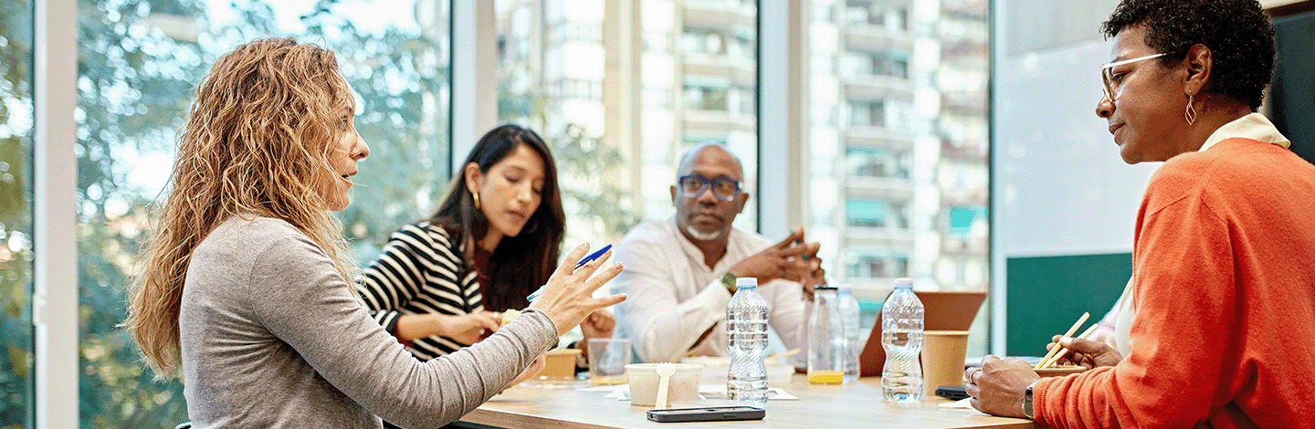 Group of people sat around a table at work talking